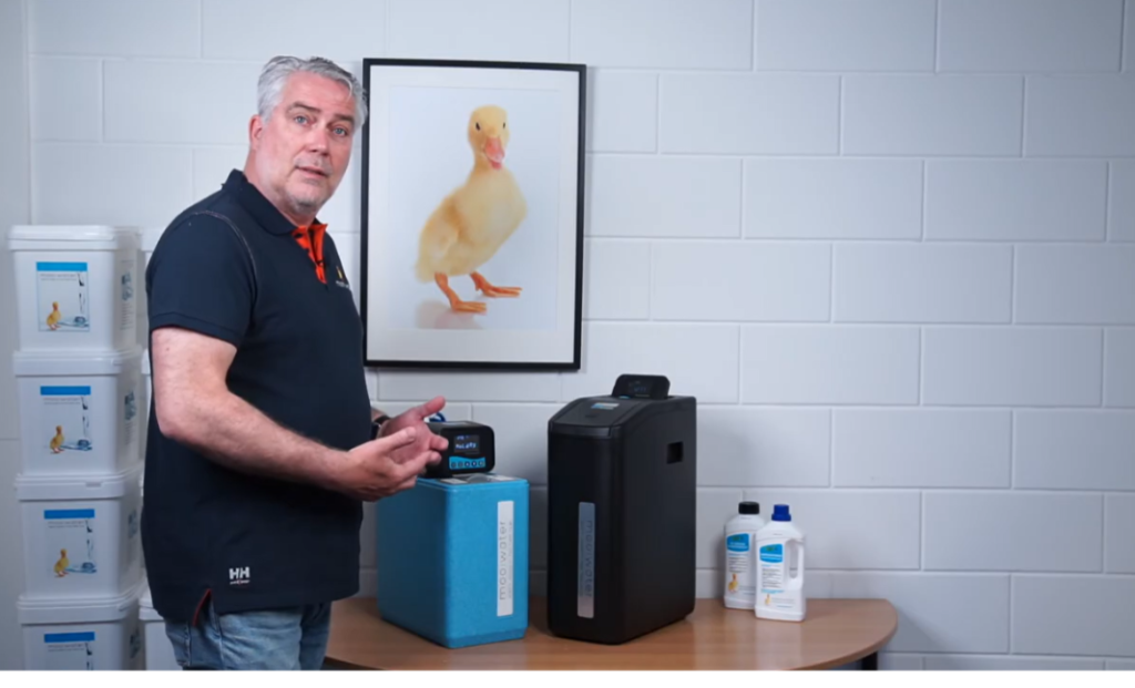 How do you put a water softener into holiday mode?